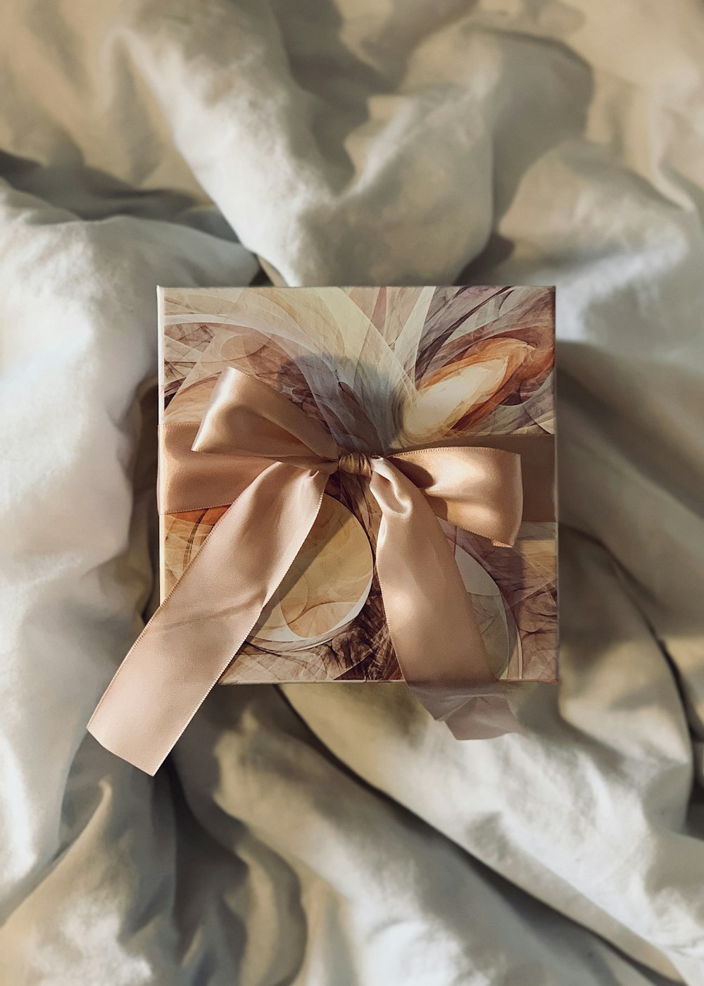An elegantly wrapped bespoke gift box with a satin ribbon